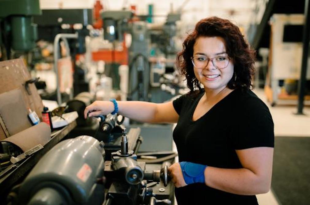 Lane Community College student working at a printing press